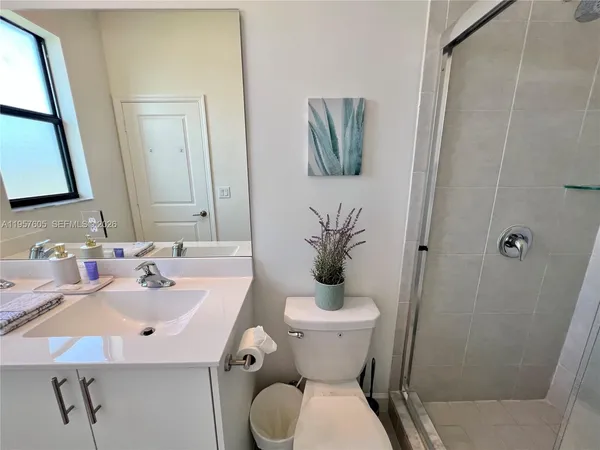 a bathroom with a sink toilet and shower