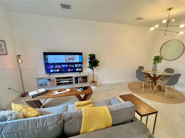 a living room with furniture and a flat screen tv