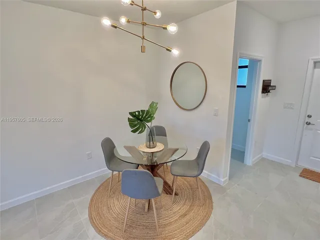 a dining room with furniture and a mirror