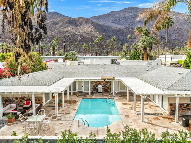 a view of a swimming pool with a patio and mountain view