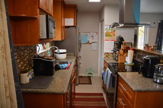 a kitchen with a sink stove and cabinets