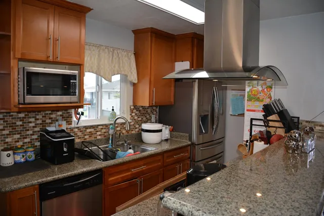 a kitchen with sink a refrigerator and cabinets