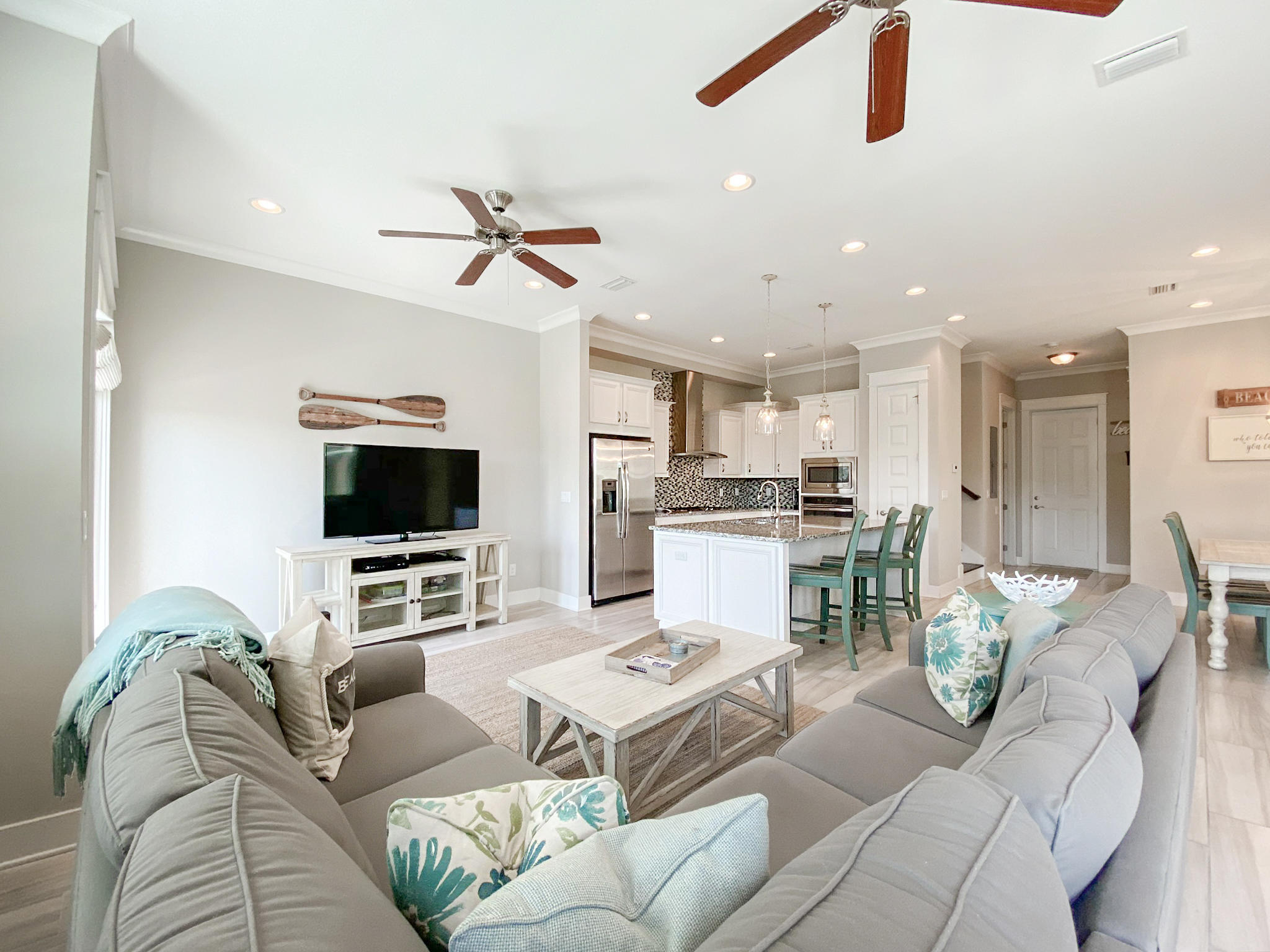 79 Milestone Dr Inlet Beach, Unit A Inlet Beach, FL 32461 - Photo 10 of 34 a living room with furniture kitchen view and a flat screen tv