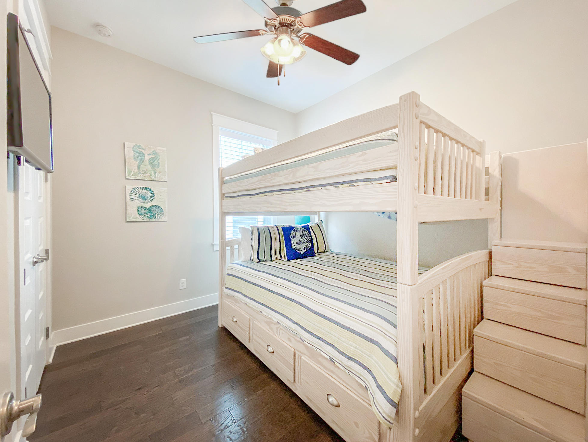 79 Milestone Dr Inlet Beach, Unit A Inlet Beach, FL 32461 - Photo 17 of 34 a view of a bedroom with wooden floor and ceiling fan