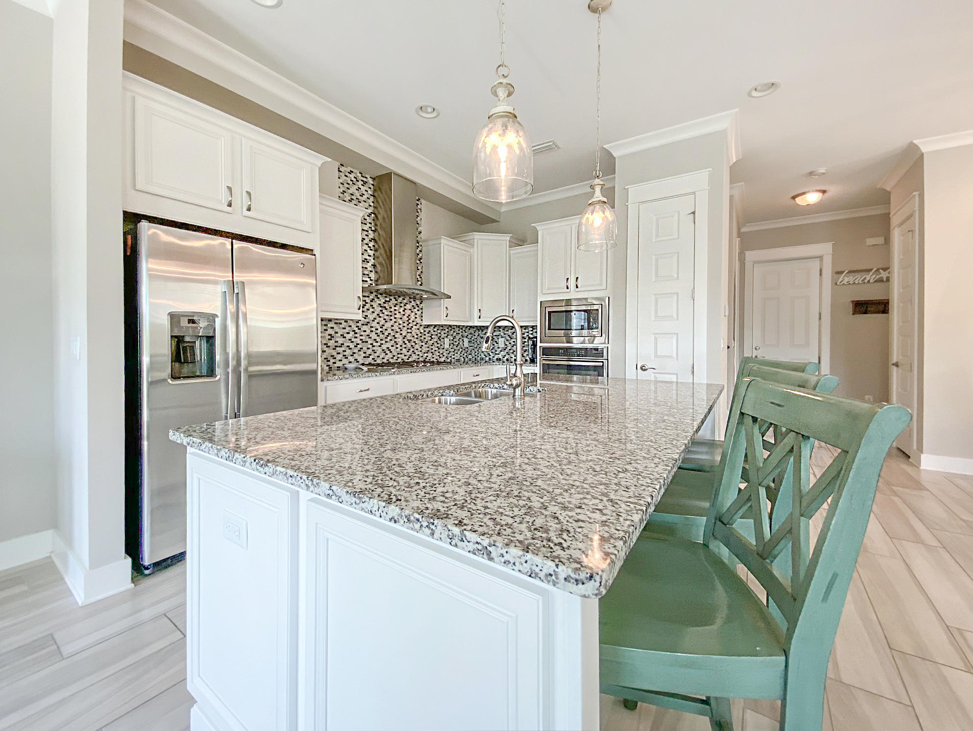 79 Milestone Dr Inlet Beach, Unit A Inlet Beach, FL 32461 - Photo 4 of 34 a kitchen with stainless steel appliances granite countertop a sink and a refrigerator