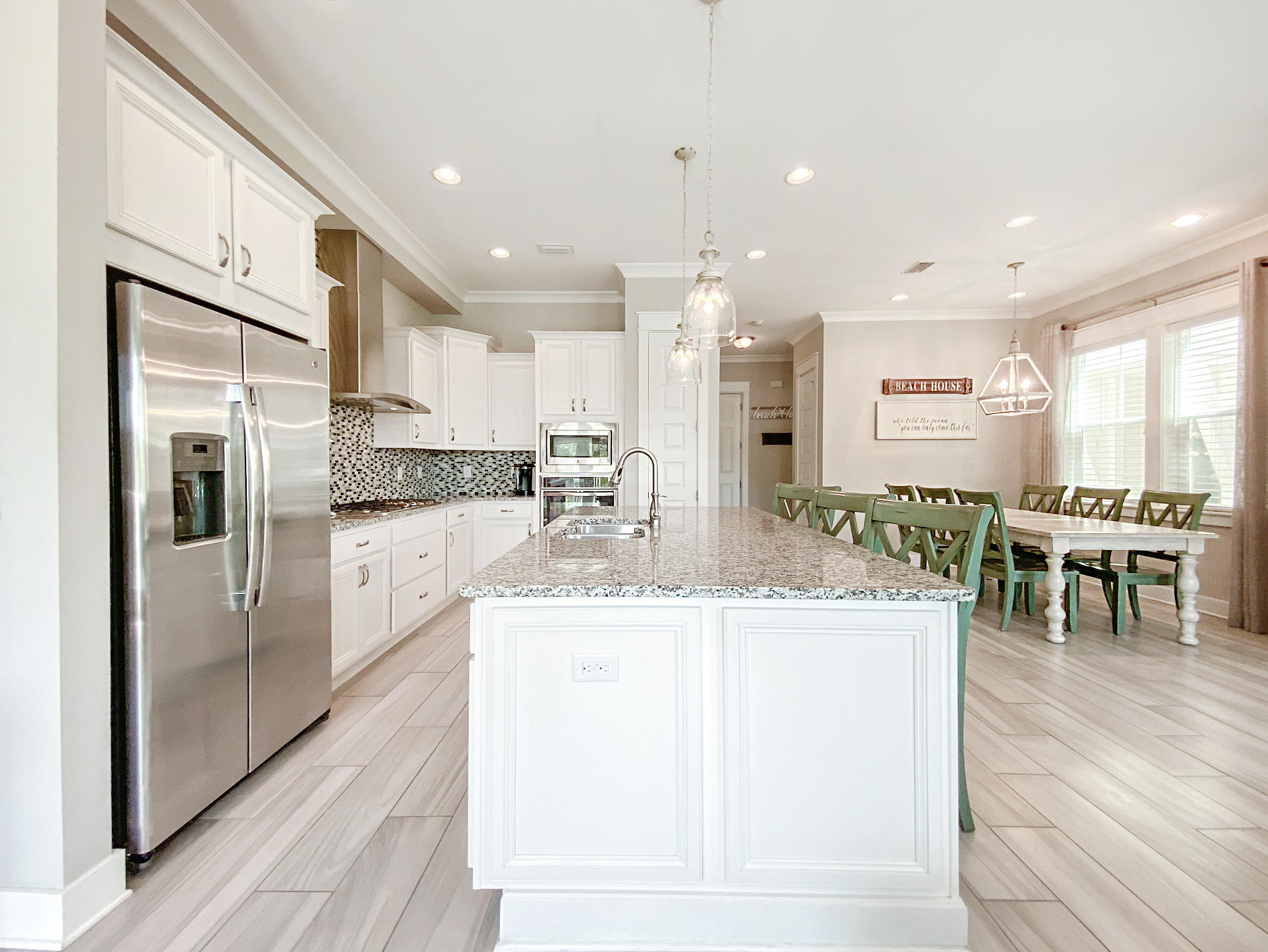 79 Milestone Dr Inlet Beach, Unit A Inlet Beach, FL 32461 - Photo 5 of 34 a kitchen with stainless steel appliances kitchen island granite countertop a refrigerator and a sink