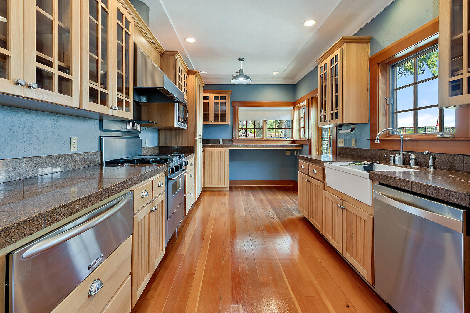 4450 Fern Valley Road Medford, OR 97504 - Photo 10 of 74 a kitchen with stainless steel appliances granite countertop lots of counter top space and wooden floor