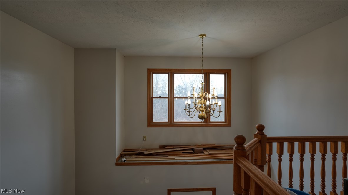 3752 Holmes Road Cambridge, OH 43725 - Photo 30 of 50 Staircase featuring a chandelier