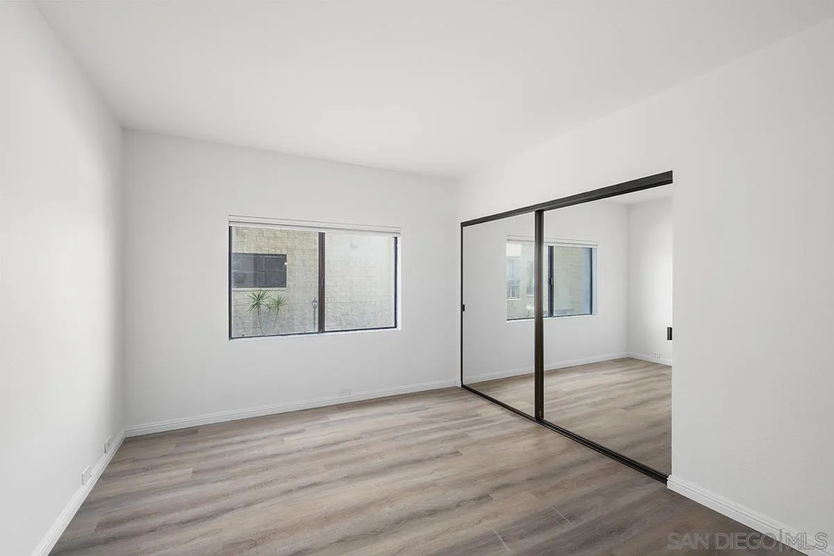 3570 1st Avenue, Unit 1 San Diego, CA 92103 - Photo 33 of 55 a view of an empty room with wooden floor and a window