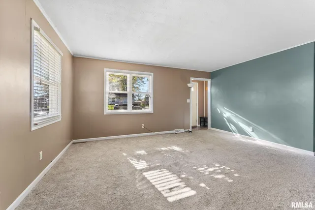 a view of an empty room with windows