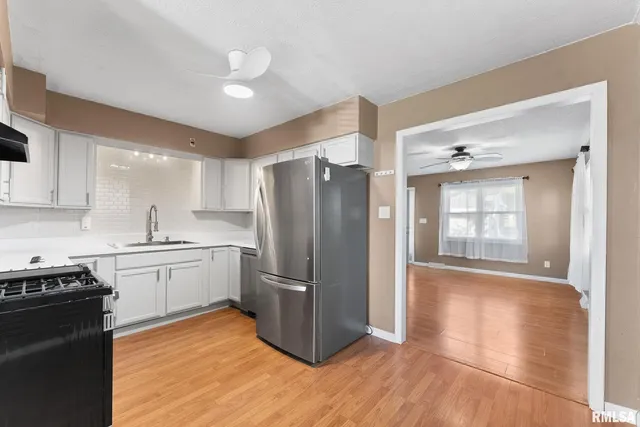 a kitchen with granite countertop stainless steel appliances and wooden cabinets