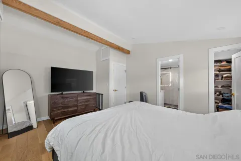 a bedroom with a bed and a flat screen tv