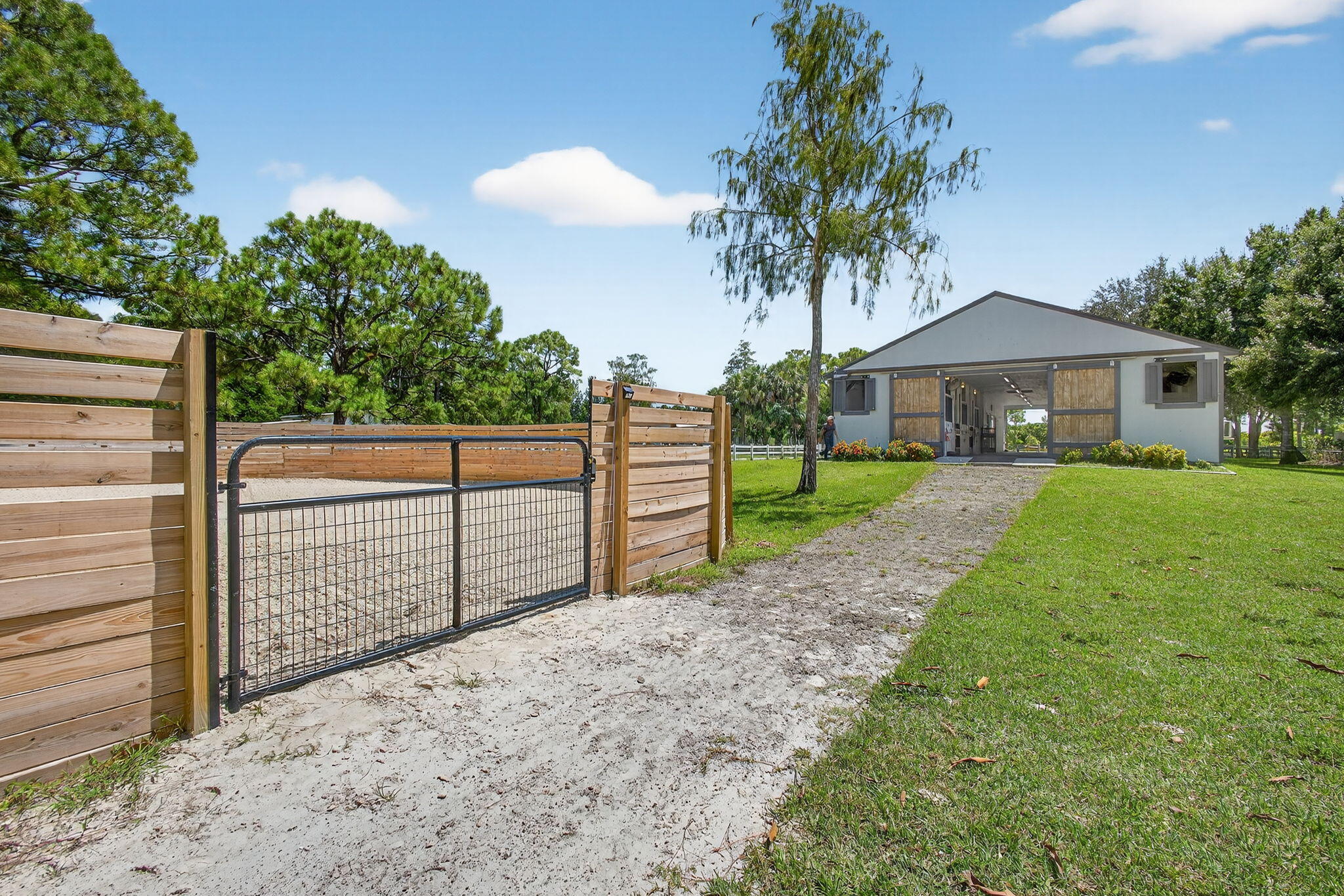 17218 Shetland Lane, Unit 2 STALLS Loxahatchee, FL 33470 - Photo 16 of 54 a front view of a house with a yard and garage