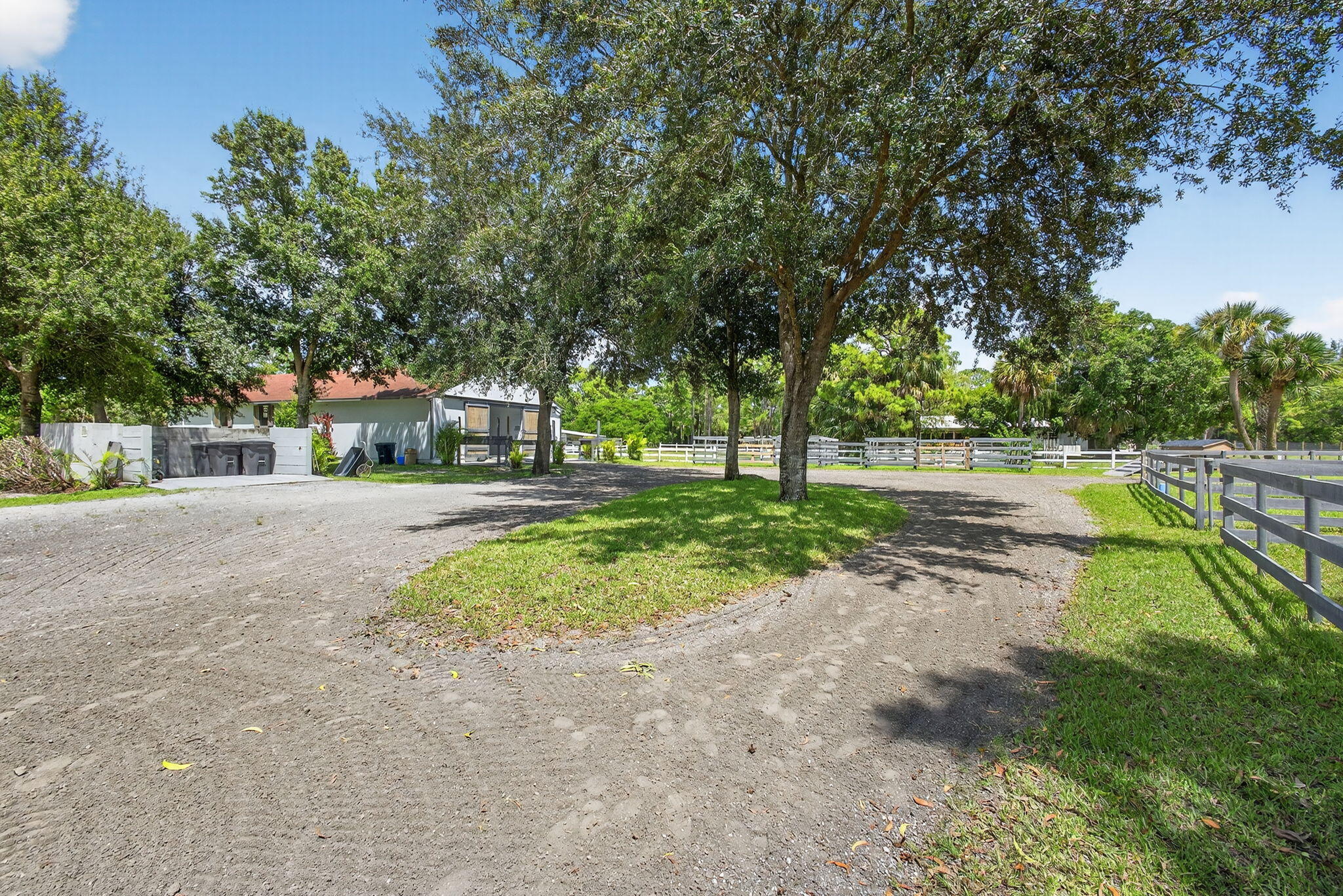 17218 Shetland Lane, Unit 2 STALLS Loxahatchee, FL 33470 - Photo 24 of 54 a house with trees in front of it
