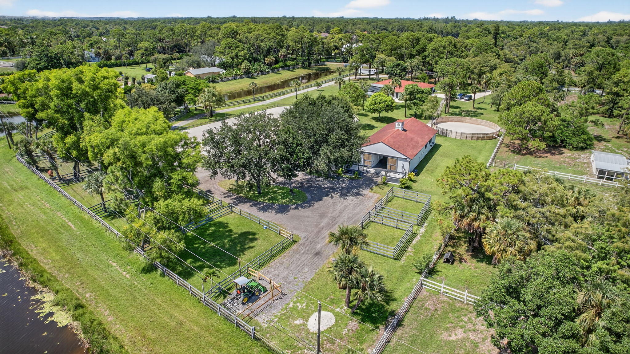 17218 Shetland Lane, Unit 2 STALLS Loxahatchee, FL 33470 - Photo 30 of 54 an aerial view of residential houses with outdoor space and trees