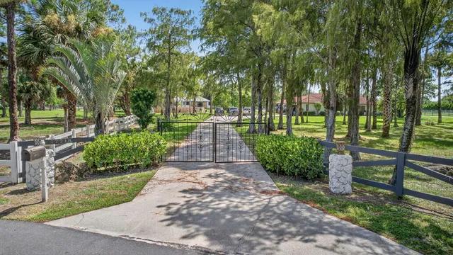 a white house with lots of green space