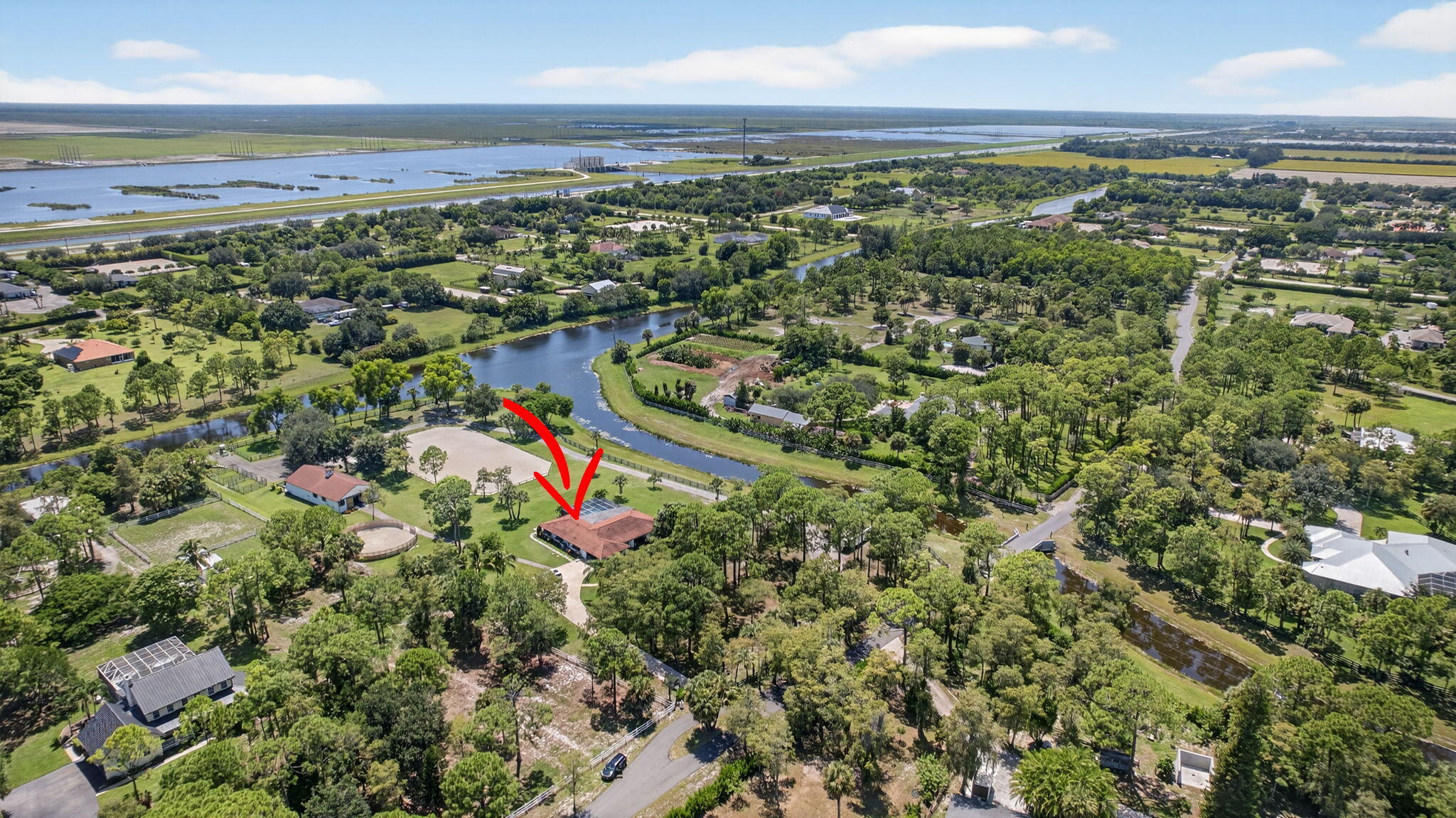 17218 Shetland Lane, Unit 2 STALLS Loxahatchee, FL 33470 - Photo 37 of 54 an aerial view of residential houses with outdoor space and trees