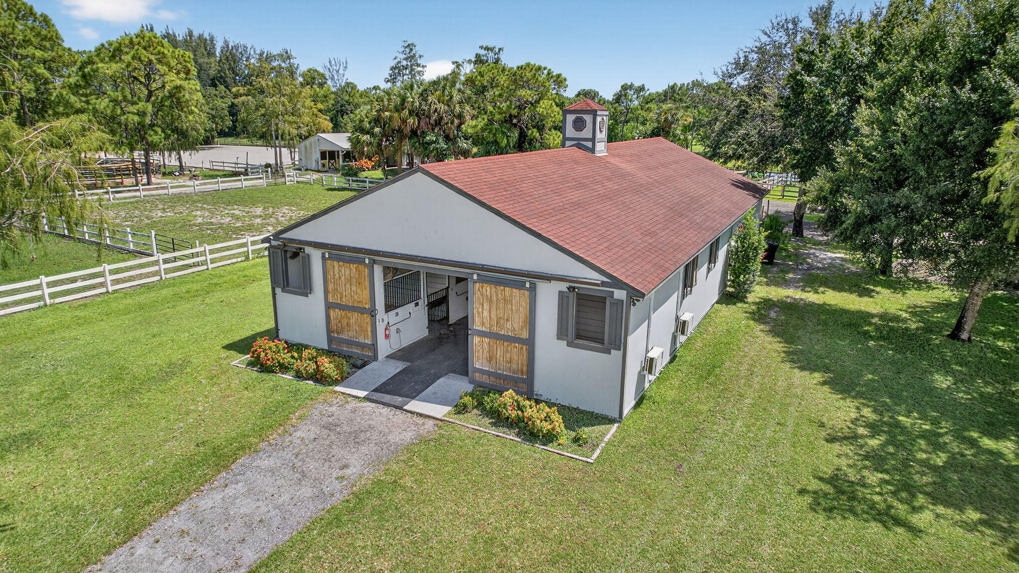 17218 Shetland Lane, Unit 2 STALLS Loxahatchee, FL 33470 - Photo 42 of 54 a aerial view of a house with a yard table and chairs