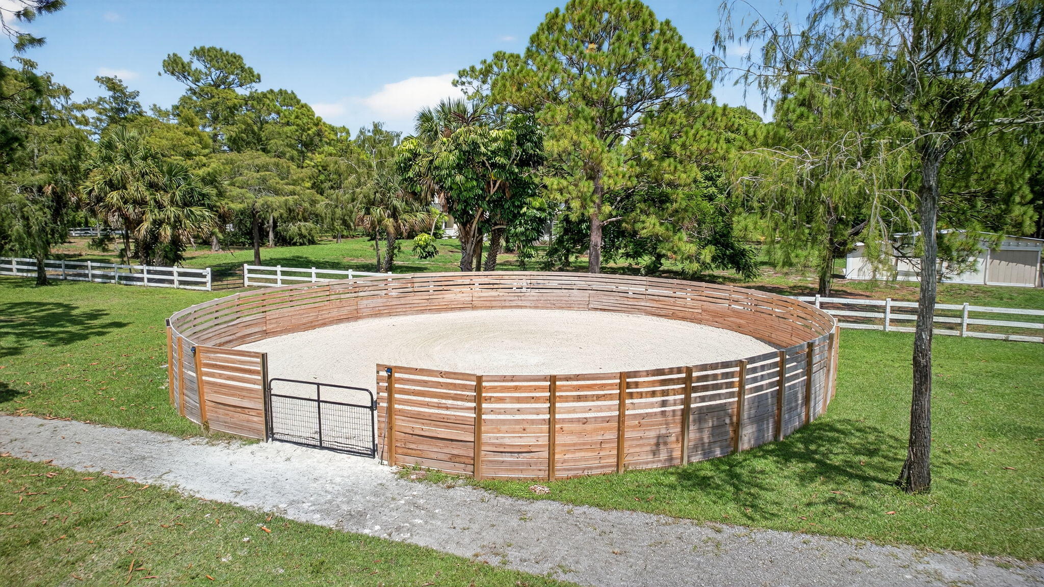 17218 Shetland Lane, Unit 2 STALLS Loxahatchee, FL 33470 - Photo 43 of 54 a view of a backyard with large trees