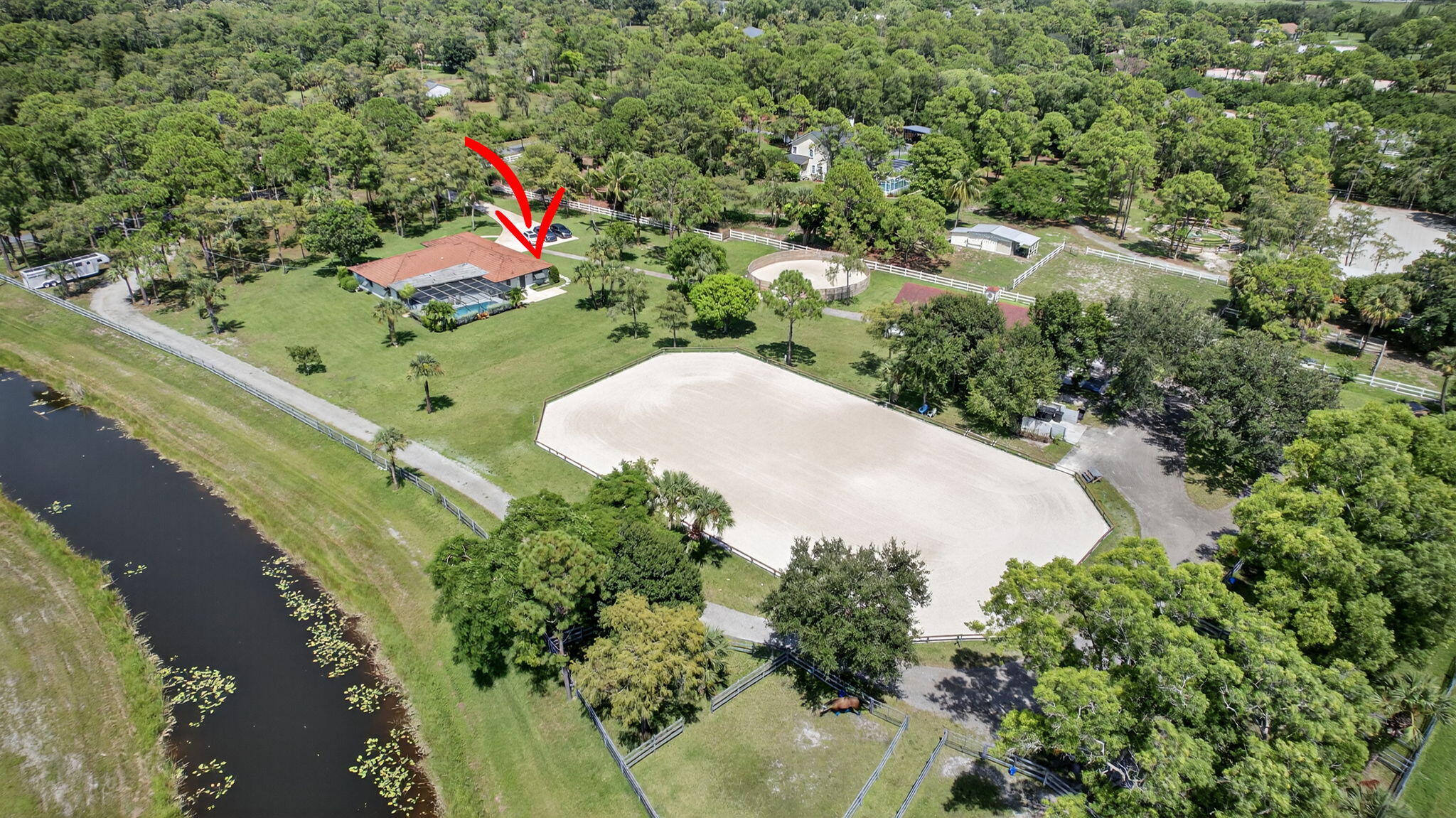 17218 Shetland Lane, Unit 2 STALLS Loxahatchee, FL 33470 - Photo 54 of 54 an aerial view of a house with a yard and lake view
