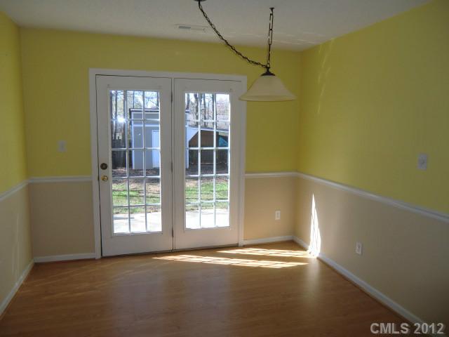 6909 Alanbrook Road Charlotte, NC 28215 - Photo 4 of 14 a view of empty room with floor to ceiling window