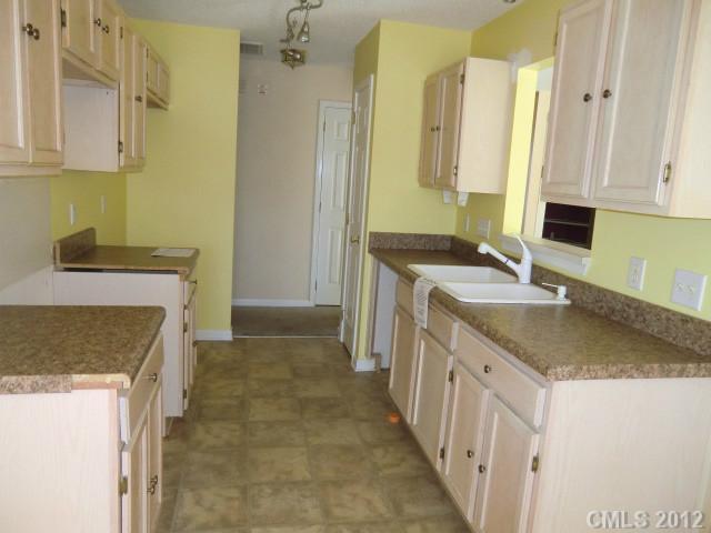 6909 Alanbrook Road Charlotte, NC 28215 - Photo 5 of 14 a bathroom with a granite countertop sink a toilet and a mirror