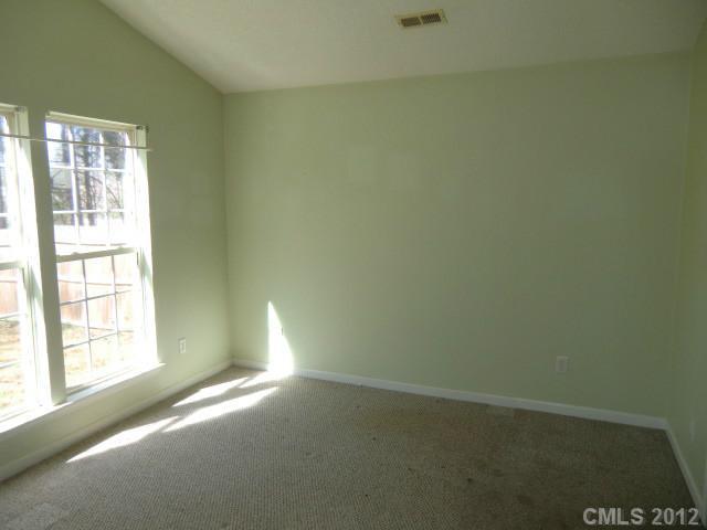 6909 Alanbrook Road Charlotte, NC 28215 - Photo 6 of 14 a view of empty room with windows