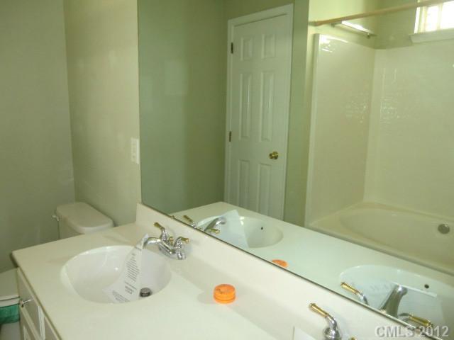 6909 Alanbrook Road Charlotte, NC 28215 - Photo 7 of 14 a bathroom with a sink and a tub