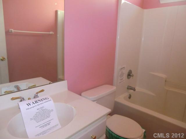 6909 Alanbrook Road Charlotte, NC 28215 - Photo 10 of 14 a bathroom with a sink a toilet and bathtub