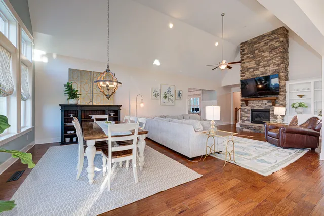 a living room with furniture a fireplace a dining table and a fireplace