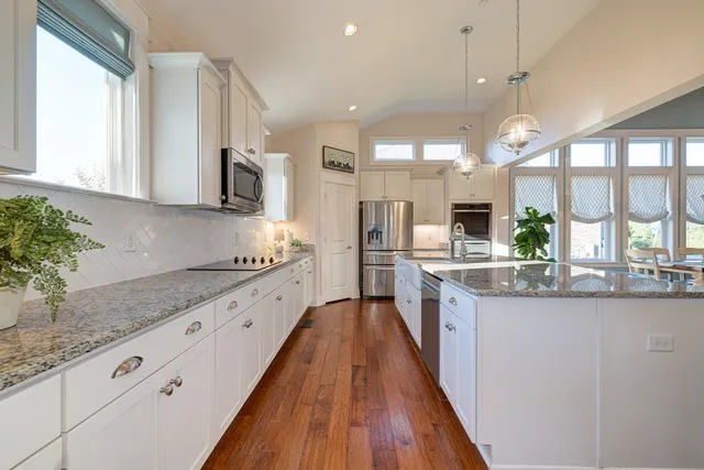 a large kitchen with granite countertop lots of counter space and window
