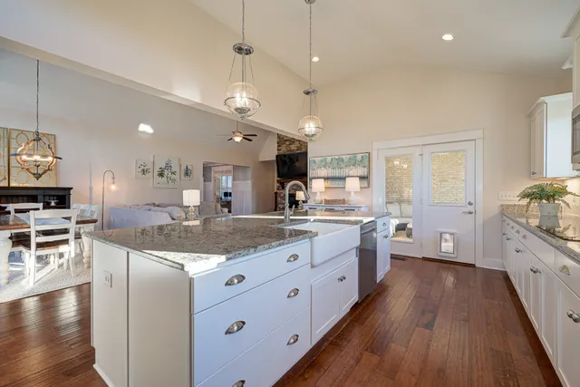 a large kitchen with kitchen island lots of counter space a sink appliances and cabinets