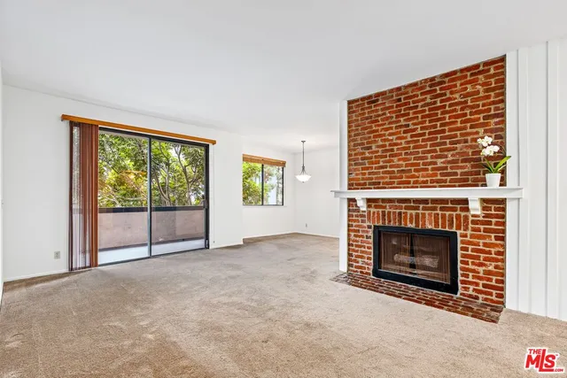 a view of empty room with a fireplace