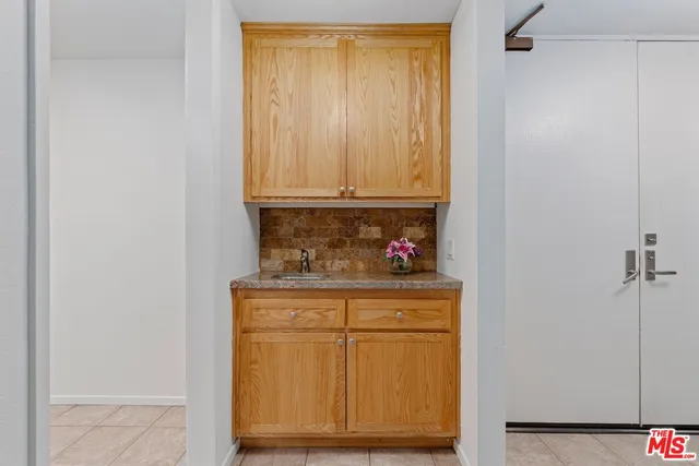 a bathroom with a granite countertop sink a toilet and a mirror