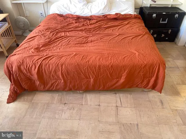 a bed sitting in a bedroom next to a lamp