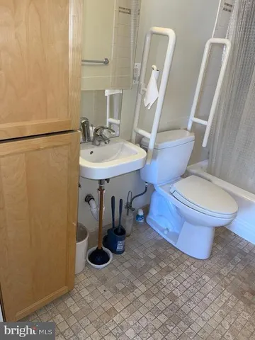 a bathroom with a sink toilet and mirror