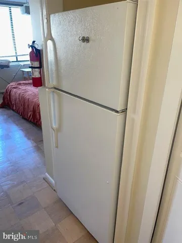 a view of walk in closet with clothes and window