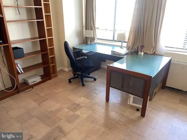 a living room with furniture gym equipment and a window