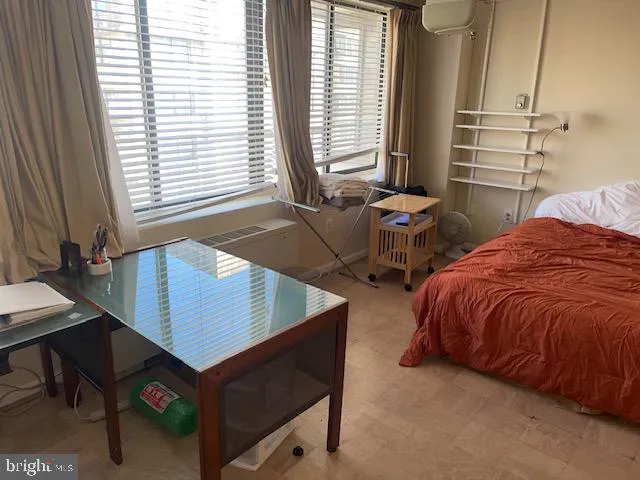 a bedroom with two beds and a window