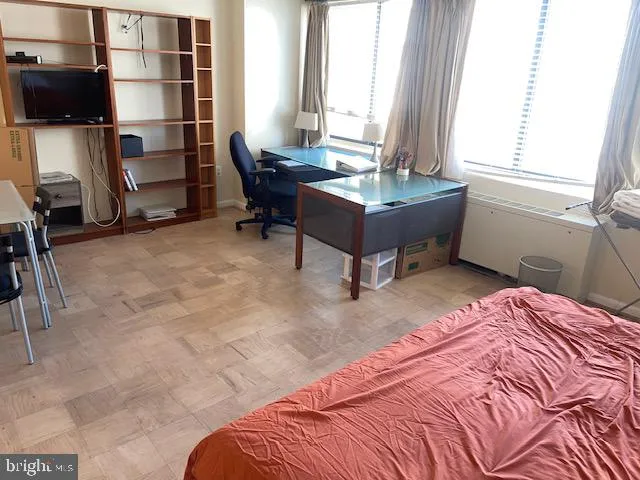 a bedroom with a bed and a chair