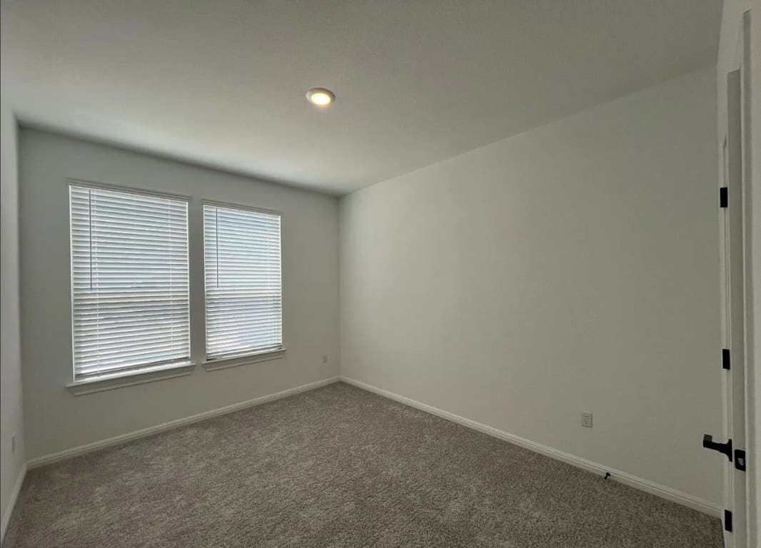 2725 Woodall Drive, Unit 204 Cedar Park, TX 78613 - Photo 11 of 14 Carpeted spare room featuring baseboards and recessed lighting