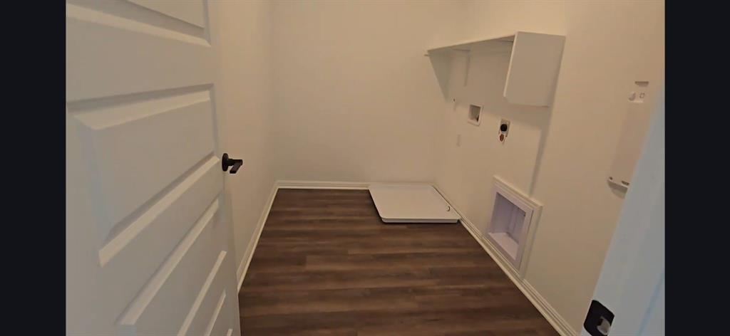 2725 Woodall Drive, Unit 204 Cedar Park, TX 78613 - Photo 12 of 14 Washroom with dark wood finished floors and washer hookup