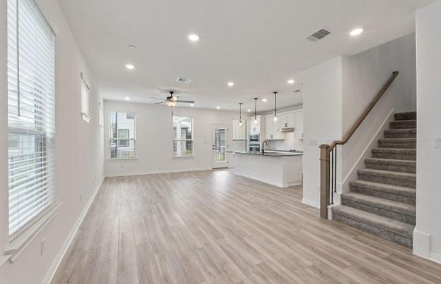 2725 Woodall Drive, Unit 204 Cedar Park, TX 78613 - Photo 4 of 14 Unfurnished living room featuring recessed lighting, light wood-type flooring, stairs, and ceiling fan