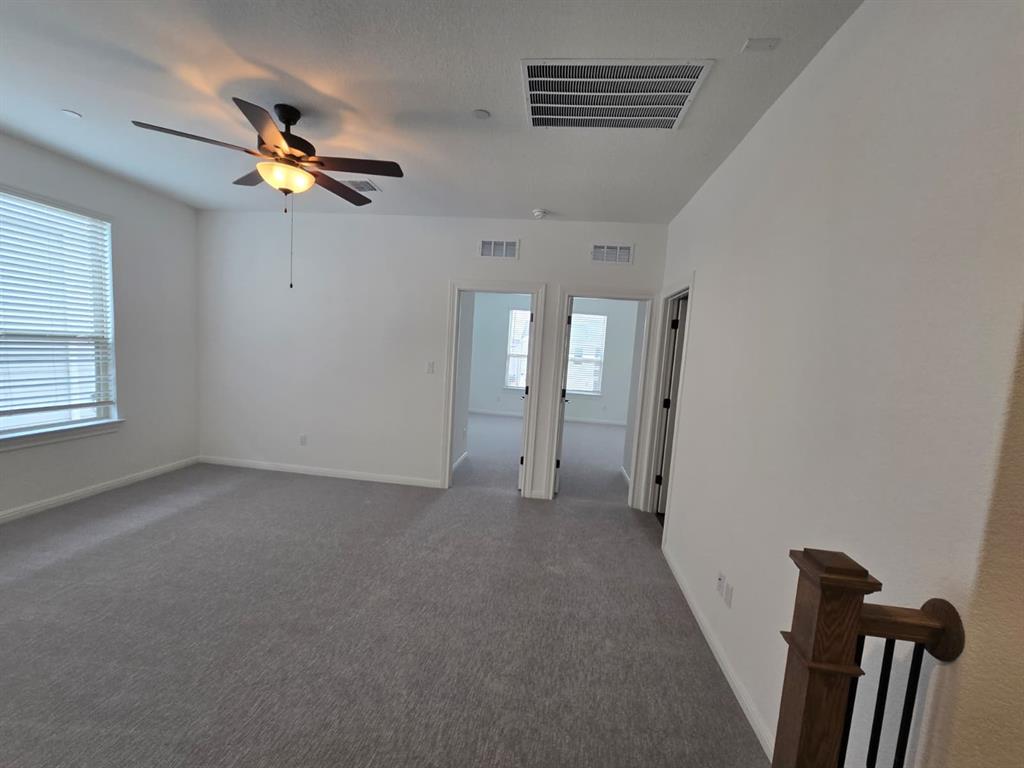 2725 Woodall Drive, Unit 204 Cedar Park, TX 78613 - Photo 5 of 14 Unfurnished room featuring carpet flooring and a ceiling fan