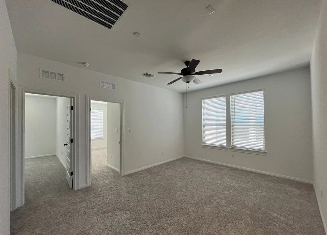 2725 Woodall Drive, Unit 204 Cedar Park, TX 78613 - Photo 6 of 14 Spare room with carpet floors and a ceiling fan