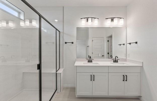 2725 Woodall Drive, Unit 204 Cedar Park, TX 78613 - Photo 8 of 14 Bathroom featuring a stall shower and double vanity