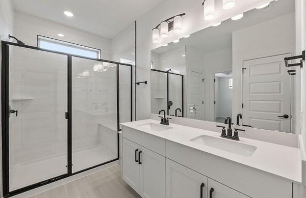 2725 Woodall Drive, Unit 204 Cedar Park, TX 78613 - Photo 9 of 14 Bathroom featuring double vanity and a stall shower