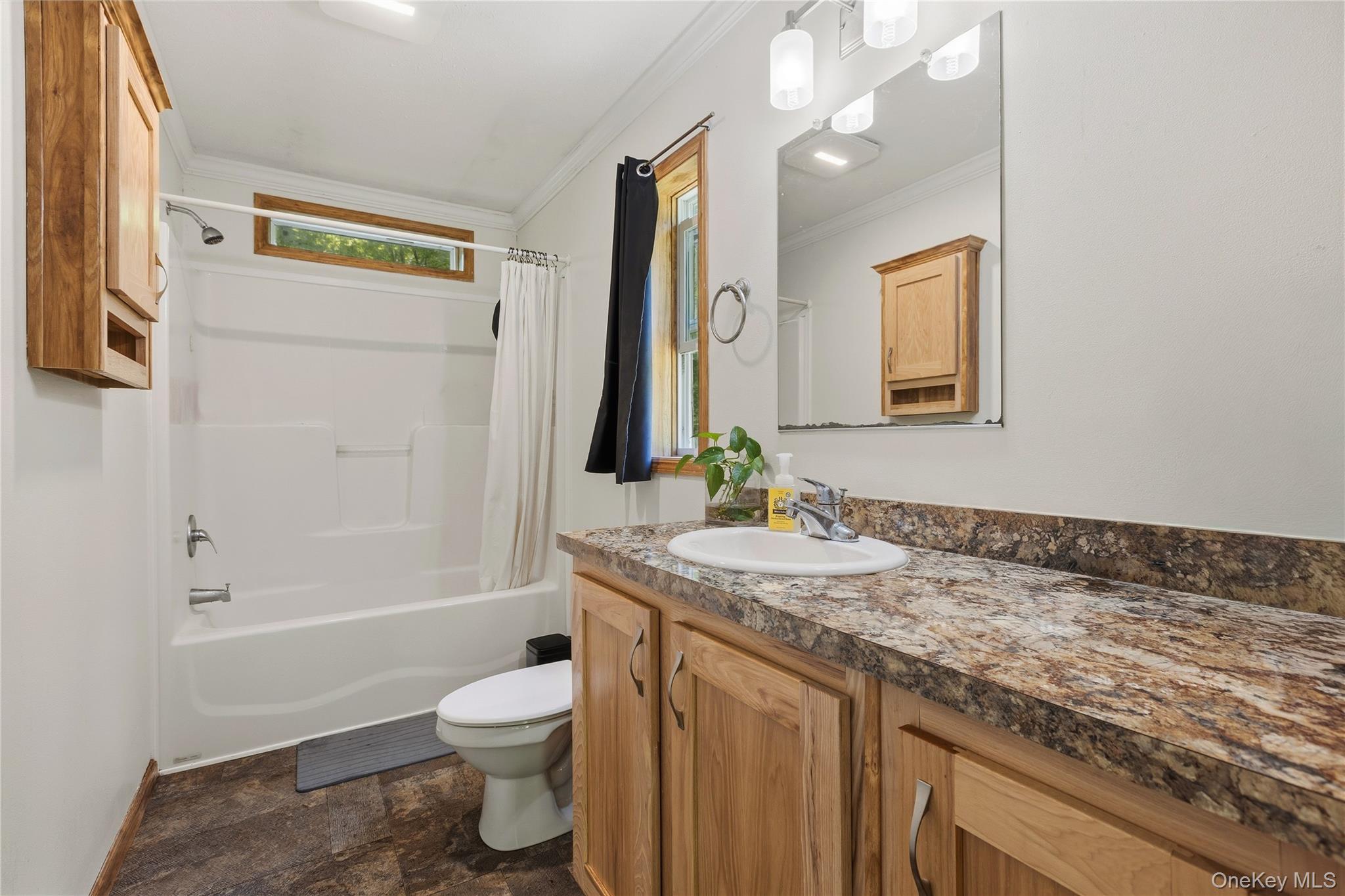 239-241 Fosler Road Highland, NY 12528 - Photo 36 of 42 Bathroom featuring a full vanity with an integrated sink, a large mirror, and a three-light fixture