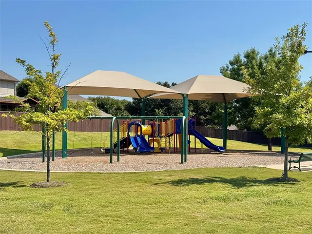 a view of a tennis ground with trees in the background