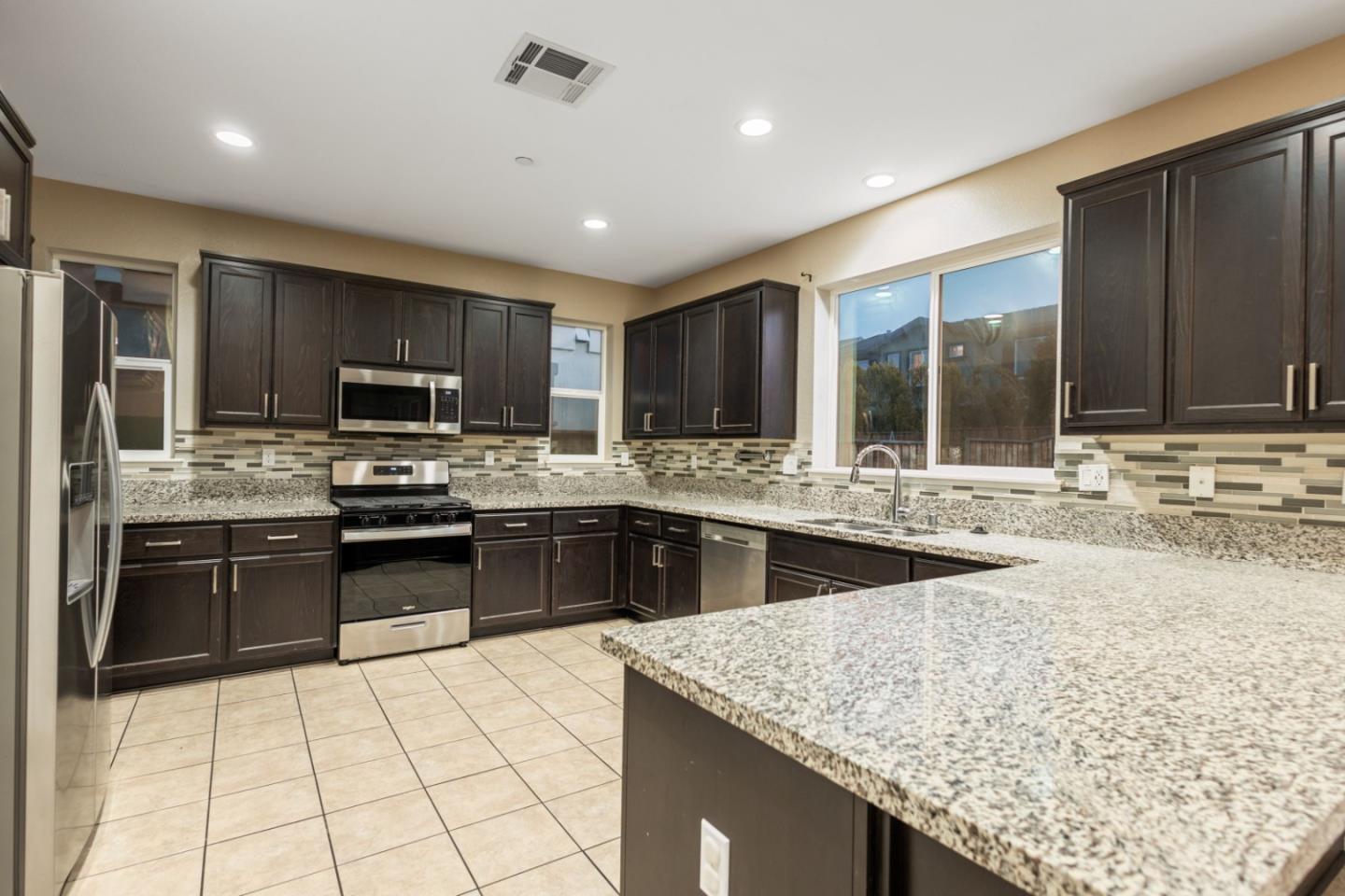 617 Copper Ridge Way Oakley, CA 94561 - Photo 11 of 27 a kitchen with stainless steel appliances granite countertop a sink counter space cabinets and stainless steel appliances